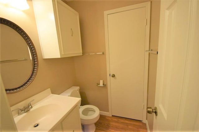 bathroom featuring hardwood / wood-style floors, toilet, and vanity