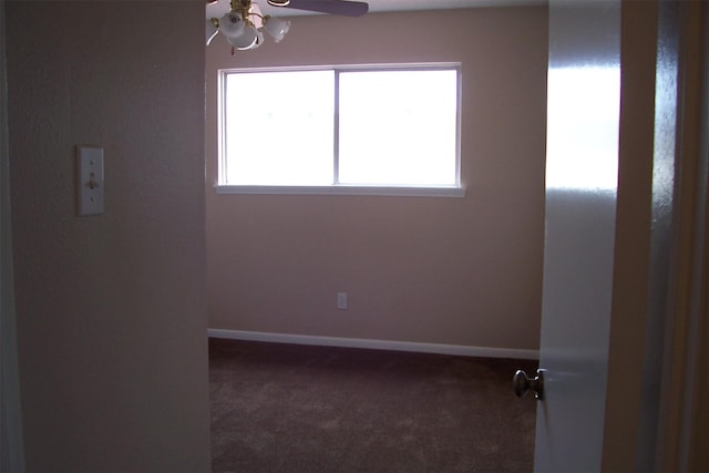 carpeted spare room featuring ceiling fan