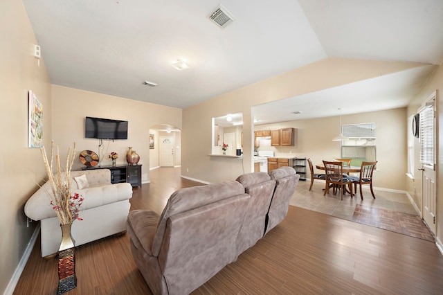 living room featuring lofted ceiling and wood-type flooring