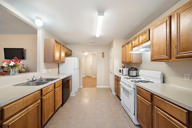 kitchen with sink, white appliances, and light tile patterned flooring