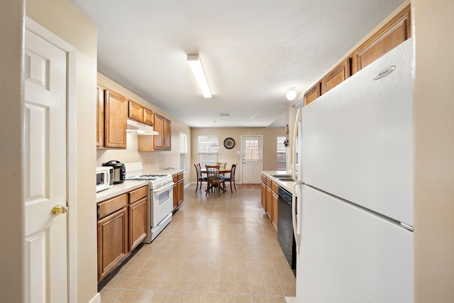 kitchen with light tile patterned floors and white appliances