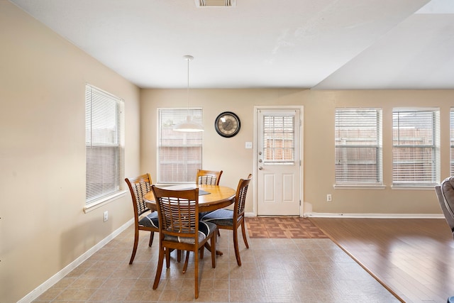 dining area with hardwood / wood-style flooring and a healthy amount of sunlight