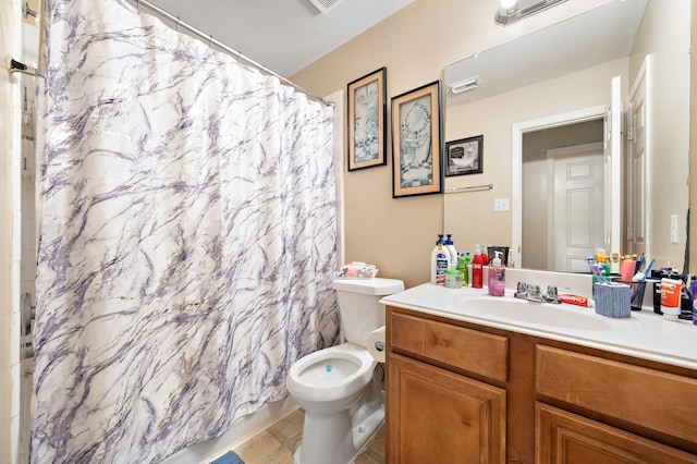 bathroom with tile patterned flooring, toilet, walk in shower, and vanity