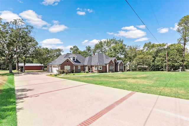 view of front facade with a garage and a front lawn