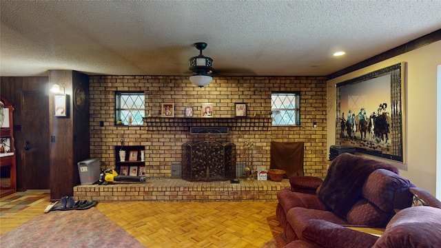 130 Dickey St, Bronson, TX 75930 - living area featuring a textured ceiling, a brick fireplace, brick wall, and a ceiling fan