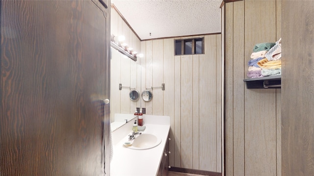 130 Dickey St, Bronson, TX 75930 - bathroom with a textured ceiling, vanity, and wooden walls