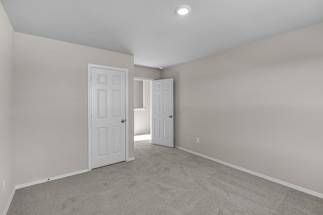 unfurnished bedroom with light carpet