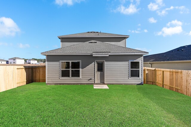 back of house featuring a yard