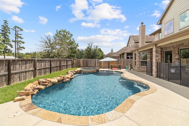 view of pool with a patio area and an in ground hot tub