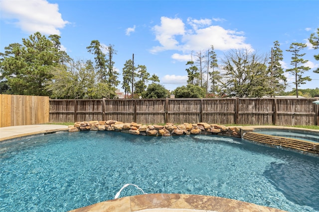 view of swimming pool featuring an in ground hot tub