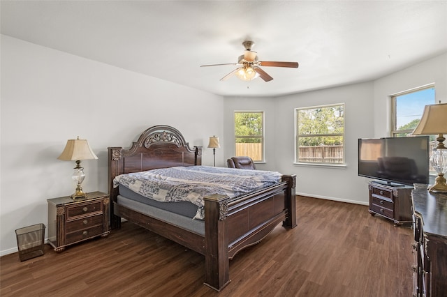 bedroom with dark hardwood / wood-style flooring and ceiling fan