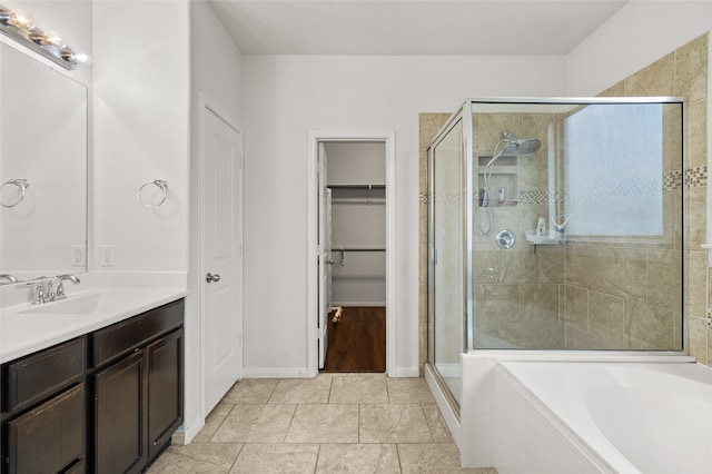 bathroom featuring vanity, independent shower and bath, and tile patterned floors