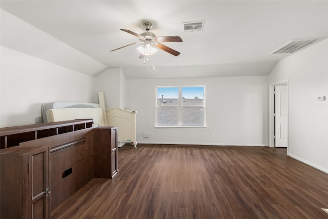 bedroom with ceiling fan, dark hardwood / wood-style floors, and vaulted ceiling