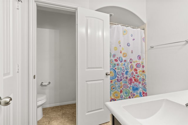 bathroom with vanity, toilet, and tile patterned floors