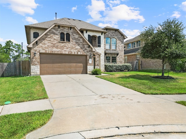 view of front of home featuring a front yard and a garage