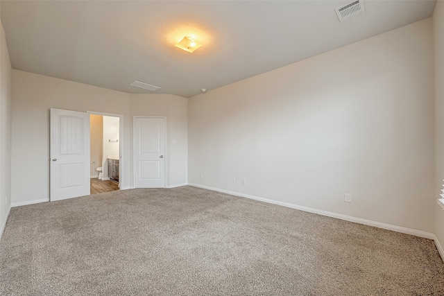 unfurnished bedroom featuring light carpet