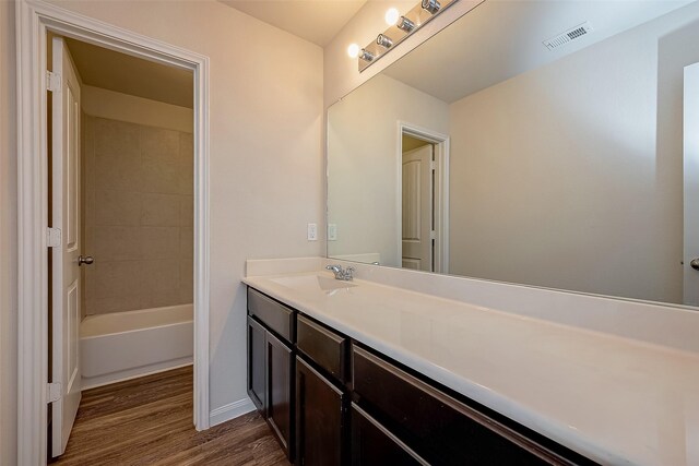 bathroom with vanity and wood-type flooring