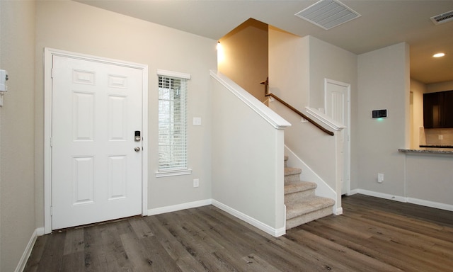 entrance foyer with a healthy amount of sunlight and dark hardwood / wood-style flooring