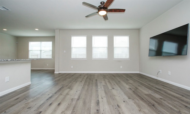 interior space with ceiling fan and wood-type flooring