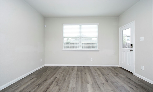 unfurnished room featuring hardwood / wood-style flooring and plenty of natural light