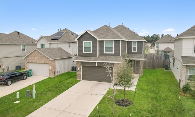 view of front of property with a garage, a front lawn, and solar panels