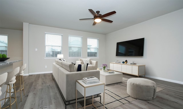 living room featuring light hardwood / wood-style flooring and ceiling fan