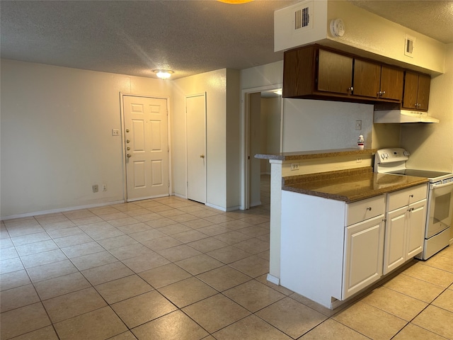 kitchen with a textured ceiling, light tile patterned floors, and white range with electric cooktop