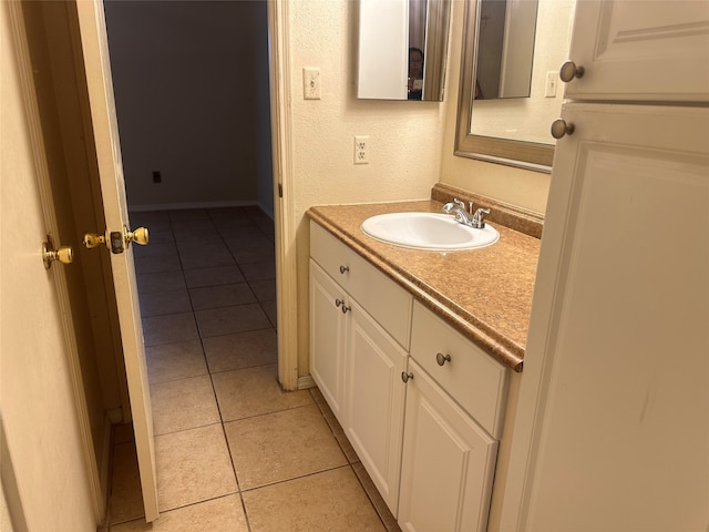 bathroom with tile patterned flooring and vanity