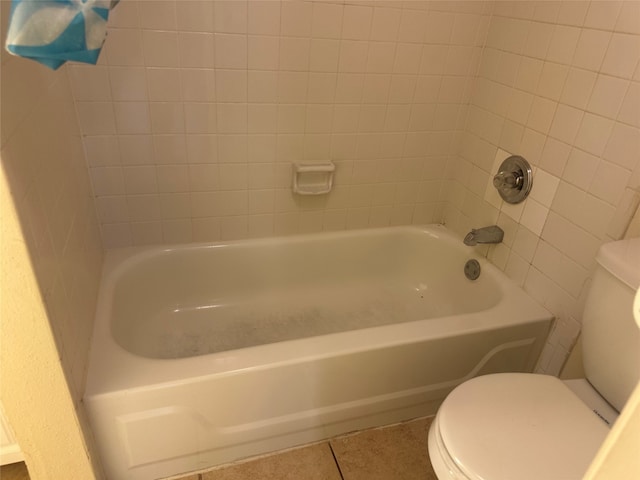 bathroom with toilet and tile patterned floors