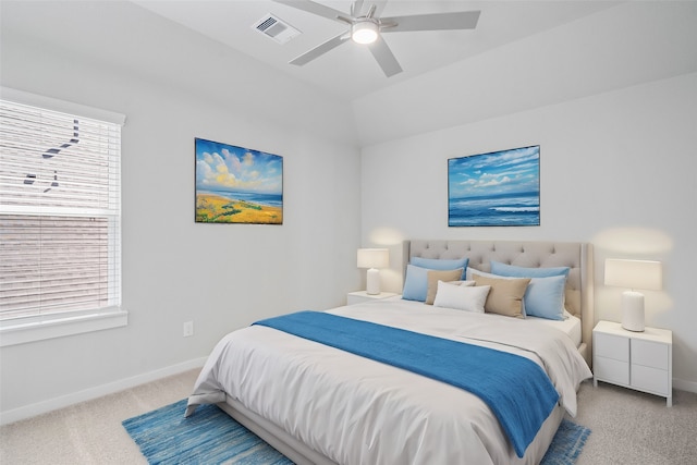 carpeted bedroom featuring multiple windows and ceiling fan