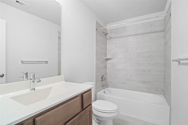 full bathroom with toilet, vanity, and tiled shower / bath