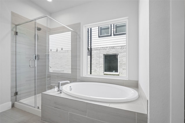 bathroom with shower with separate bathtub and tile patterned floors