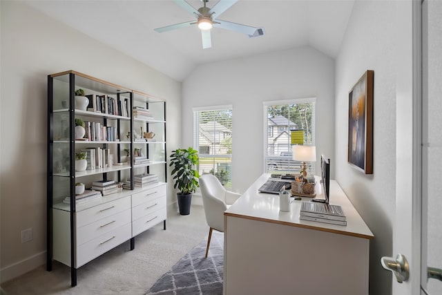 carpeted office with lofted ceiling and ceiling fan