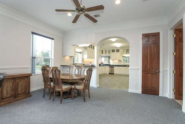 carpeted dining area featuring ceiling fan and ornamental molding