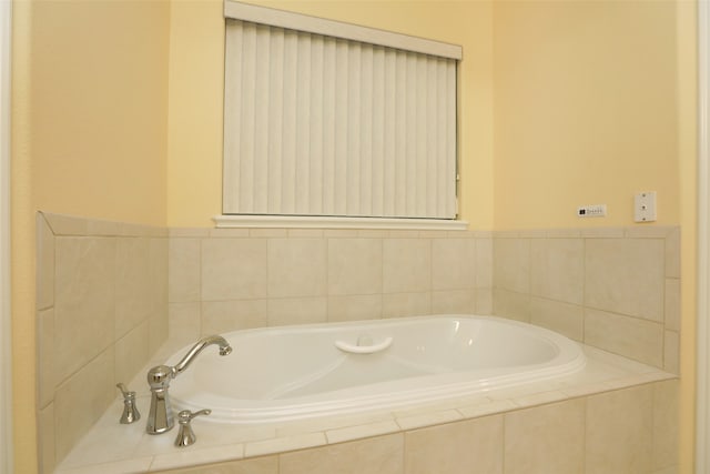 bathroom featuring tiled tub