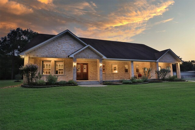 view of front of property featuring a yard and covered porch