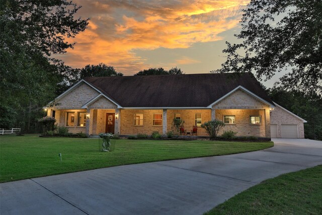 view of front of property with a lawn and a garage