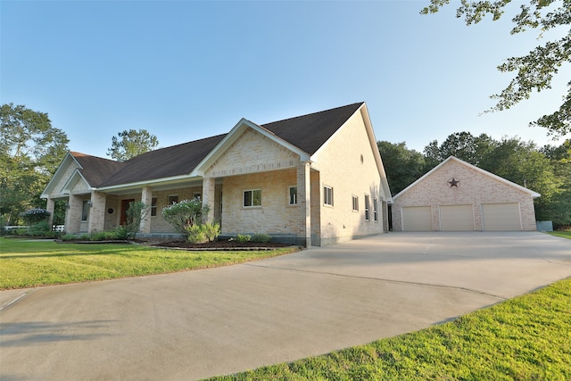 exterior space featuring an outdoor structure, a garage, and a yard