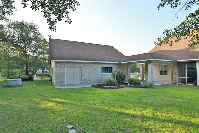 back of property featuring a yard and a patio