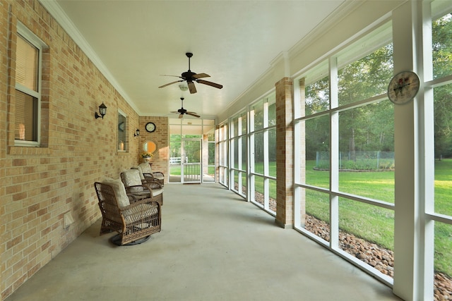 unfurnished sunroom with a wealth of natural light and ceiling fan