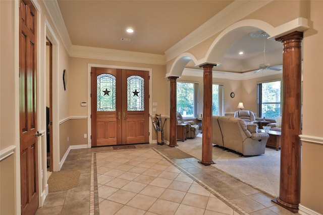 entrance foyer with french doors, ceiling fan, ornamental molding, and ornate columns