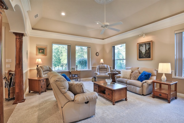 living room featuring carpet floors, a tray ceiling, decorative columns, crown molding, and ceiling fan