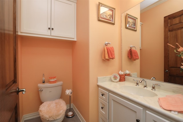 bathroom featuring crown molding, vanity, and toilet