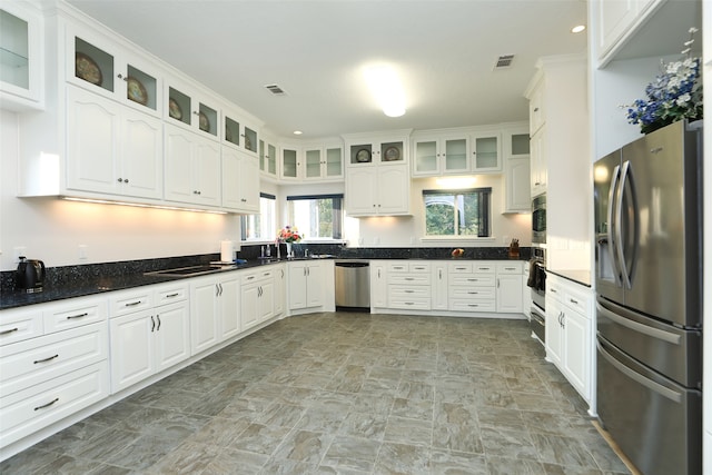 kitchen featuring stainless steel appliances and white cabinets