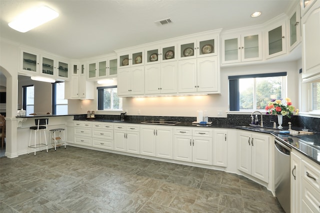 kitchen featuring stainless steel dishwasher, sink, and white cabinetry