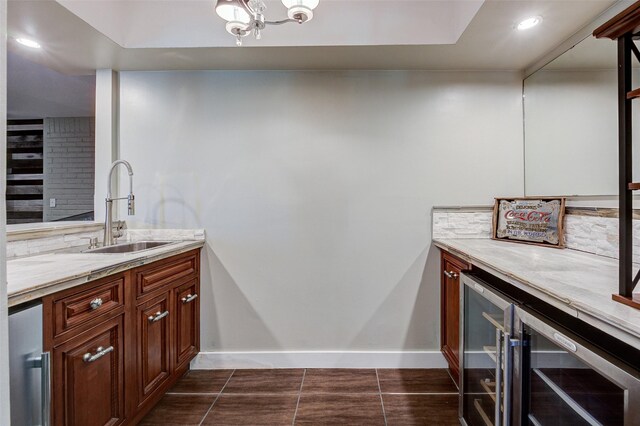 bathroom with tile patterned flooring, vanity, beverage cooler, and an inviting chandelier