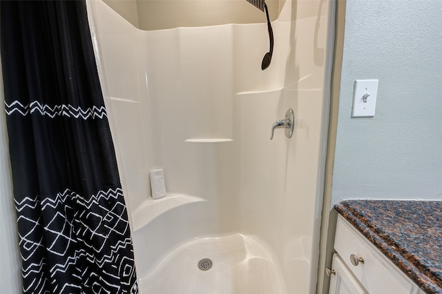 bathroom with vanity and walk in shower