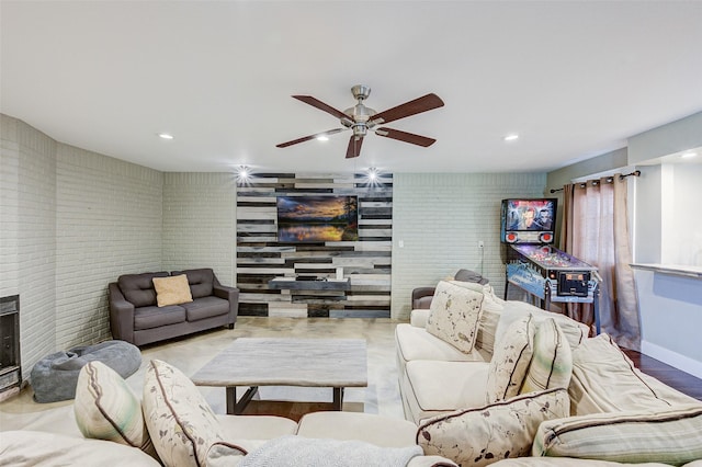 living area featuring ceiling fan, baseboards, and recessed lighting