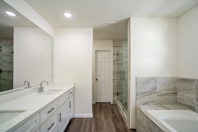 bathroom featuring vanity, hardwood / wood-style flooring, and independent shower and bath