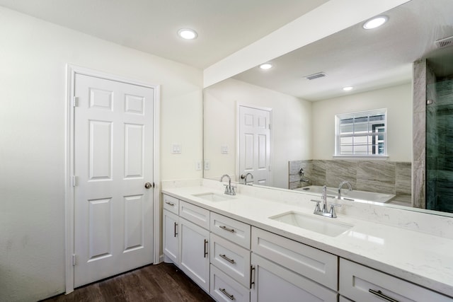 bathroom featuring vanity, wood-type flooring, and separate shower and tub